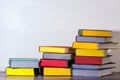 Concept of education and preparation for school. Split-level of colorful book stacks on the white background.