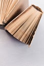 Concept of education  teaching literature  library. Spine end of an open old shabby book  pages fanned out on a background with Royalty Free Stock Photo