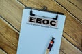 Concept of EEOC - Equal Employment Opportunity Commision write on paperwork isolated on Wooden Table