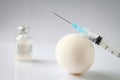Egg based manufacturing of a vaccine. Broken egg, medical vial of injectable medicine and hypodermic needle
