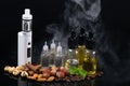 The concept of electronic cigarettes and nuts on a background of smoke Royalty Free Stock Photo
