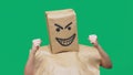 Concept of emotion, gestures. a man with a package on his head, with a painted smiley angry, sly, gloating Royalty Free Stock Photo