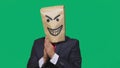 Concept of emotion, gestures. a man with a package on his head, with a painted smiley angry, sly, gloating Royalty Free Stock Photo