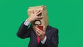 Concept of emotions, gestures. a man with paper bags on his head, with a painted emoticon, fear. talking on a cell phone Royalty Free Stock Photo