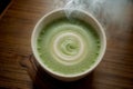 Enchanting Swirls Captivating Aerial View of a Hot Matcha Brew.AI Generated