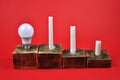 LED lamp and candles on a red background Royalty Free Stock Photo