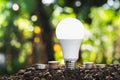 concept energy saving lightbulb with money stack. idea business Royalty Free Stock Photo