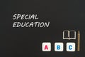 Abc letters and chipboard miniature on blackboard with text special education