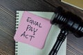 Concept of Equal Pay Act write on sticky notes with gavel isolated on Wooden Table Royalty Free Stock Photo