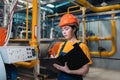 Concept of equality. A young female worker in uniform and helmet with a folder and a pen in her hand, writing meter readings. In Royalty Free Stock Photo