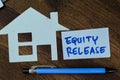 Concept of Equity Release write on sticky notes isolated on Wooden Table