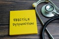 Concept of Erectile Dysfunction write on sticky notes with stethoscope isolated on Wooden Table Royalty Free Stock Photo