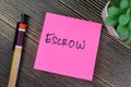 Concept of Escrow write on sticky notes isolated on Wooden Table