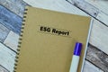 Concept of ESG Report write on book isolated on Wooden Table