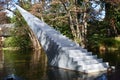 Concept of eternity and infinity. Stairs sculpture with pointy tip entitled Diminish and Ascend rising from water to air Royalty Free Stock Photo