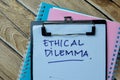 Concept of Ethical Dilemma write on paperwork isolated on Wooden Table