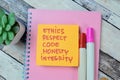 Concept of Ethics, Respect, Code, Honesty, Integrity write on sticky notes isolated on Wooden Table Royalty Free Stock Photo