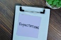 Concept of Expectations write on sticky notes isolated on Wooden Table Royalty Free Stock Photo