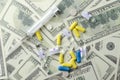 Concept of expensive health care.Pills and syringe on the banknote background Royalty Free Stock Photo