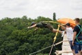 Concept of Extreme Sports and Fun. One  man is a  thrill-seeker and a  rope jumper from the bridge. He is very happy to make a Royalty Free Stock Photo