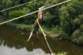 Concept of Extreme Sports and Fun. One  man is a  thrill-seeker and a  rope jumper from the bridge. He is very happy to make a Royalty Free Stock Photo