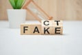 Concept of fact and fake on wooden cubes