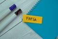 Concept of FAFSA write on sticky notes isolated on Wooden Table