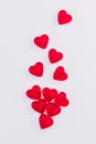 Concept of falling hearts made of heart shaped red jelly sweets on isolated white background. Top view. Royalty Free Stock Photo