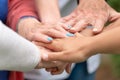 Concept of family, aging society or teamwork, hands showing unity with putting hands together, senior wrinkled hands of