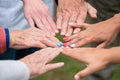 Concept of family, aging society or teamwork, hands showing unity with putting hands together, senior wrinkled hands of