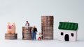 Pile of coins and miniature people. Royalty Free Stock Photo