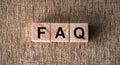 Concept of FAQ word on wooden cubes on table. Closeup Royalty Free Stock Photo