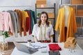 Concept of fashion and designer,Woman fashion designer stylish with measuring tape on neck sitting and smiling while workin about