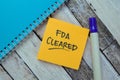 Concept of FDA Cleared write on sticky notes isolated on Wooden Table Royalty Free Stock Photo