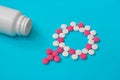Concept Female health, female contraception. Gender symbol made from pink and white pills or tablets with the bottle on Royalty Free Stock Photo