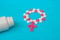 Concept Female health, female contraception. Gender symbol made from pink and white pills or tablets with the bottle on Royalty Free Stock Photo