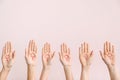 Women with drawn symbols of woman on their palms against color background. Concept of feminism