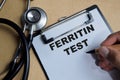 Concept of ferritin test write on clipboard isolated on Wooden Table Royalty Free Stock Photo