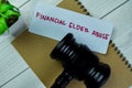 Concept of Financial Elder Abuse write on sticky notes isolated on Wooden Table