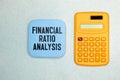 Concept of Financial Ratio Analysis write on sticky notes and stock market isolated on Wooden Table Royalty Free Stock Photo