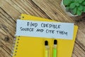 Concept of Find Credible Source and Cite Them write on sticky notes isolated on Wooden Table