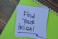 Concept of Find Your Ikigai write on sticky notes isolated on Wooden Table