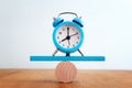 Concept of finding the right balance. vintage clock on seesaw Royalty Free Stock Photo