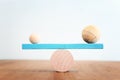 Concept of finding the right balance. Wooden balls and cubes on seesaw Royalty Free Stock Photo