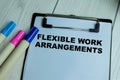 Concept of Flexible Work Arrangements write on paperwork isolated on wooden background Royalty Free Stock Photo