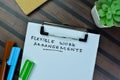 Concept of Flexible work Arrangements write on paperwork isolated on Wooden Table Royalty Free Stock Photo