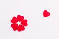 Concept of flower made of heart shaped red jelly sweets on isolated white background. Top view.