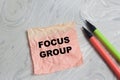Concept of focus group write on sticky notes isolated on Wooden Table Royalty Free Stock Photo