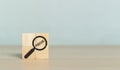 Concept Focus Target. Wooden block cube with magnifier glass and word FOCUS. Discovery search goal success Royalty Free Stock Photo