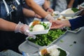 Concept of food sharing for the poor to alleviate hunger : Social Problems of Poverty Helped by Feeding : Donate food to people in Royalty Free Stock Photo